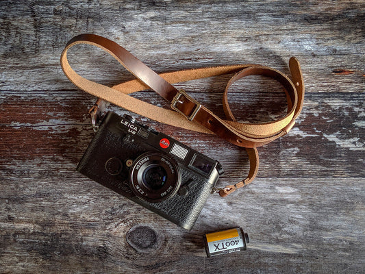 Vintage film camera with leather neck strap for film photography