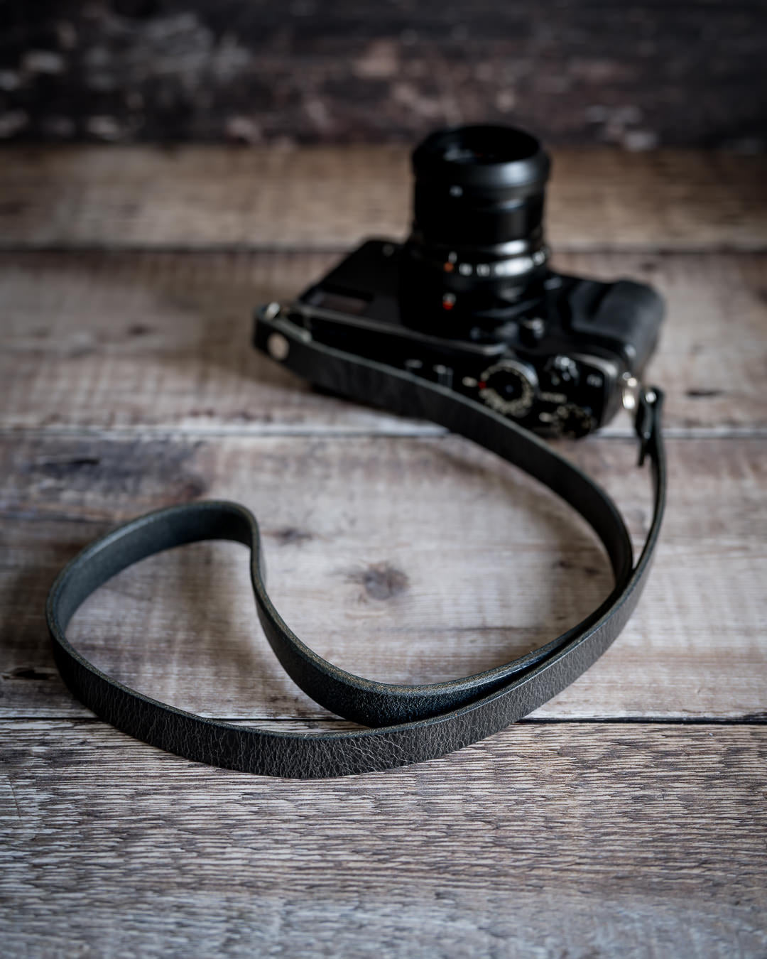 Premium buffalo hide leather camera strap showing natural grain and patina