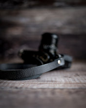 Load image into Gallery viewer, Handcrafted antique black leather strap attached to Fujifilm X-Pro1 camera