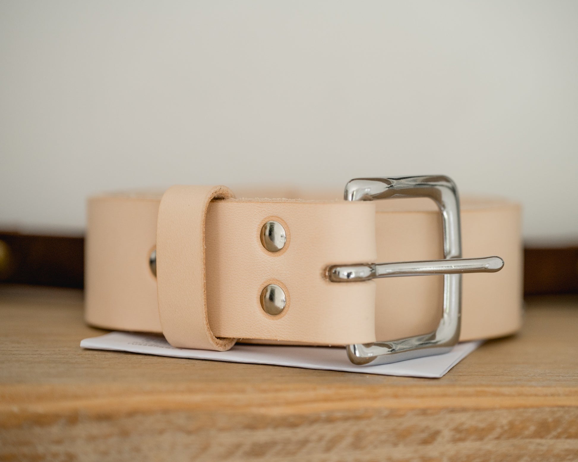 Premium veg tan leather belt showing natural grain and patina development