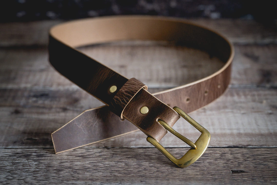 Brass buckle detail on handmade antique brown leather belt