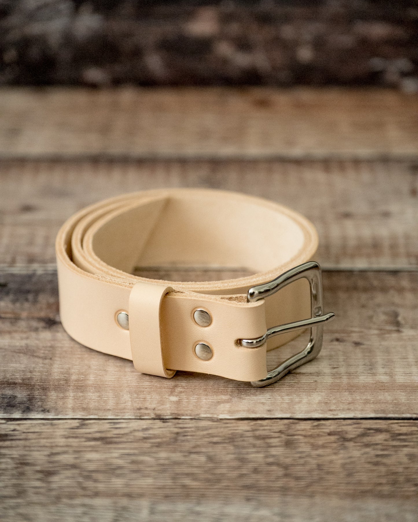 Close-up of hand-stitched keeper on natural veg tan leather belt