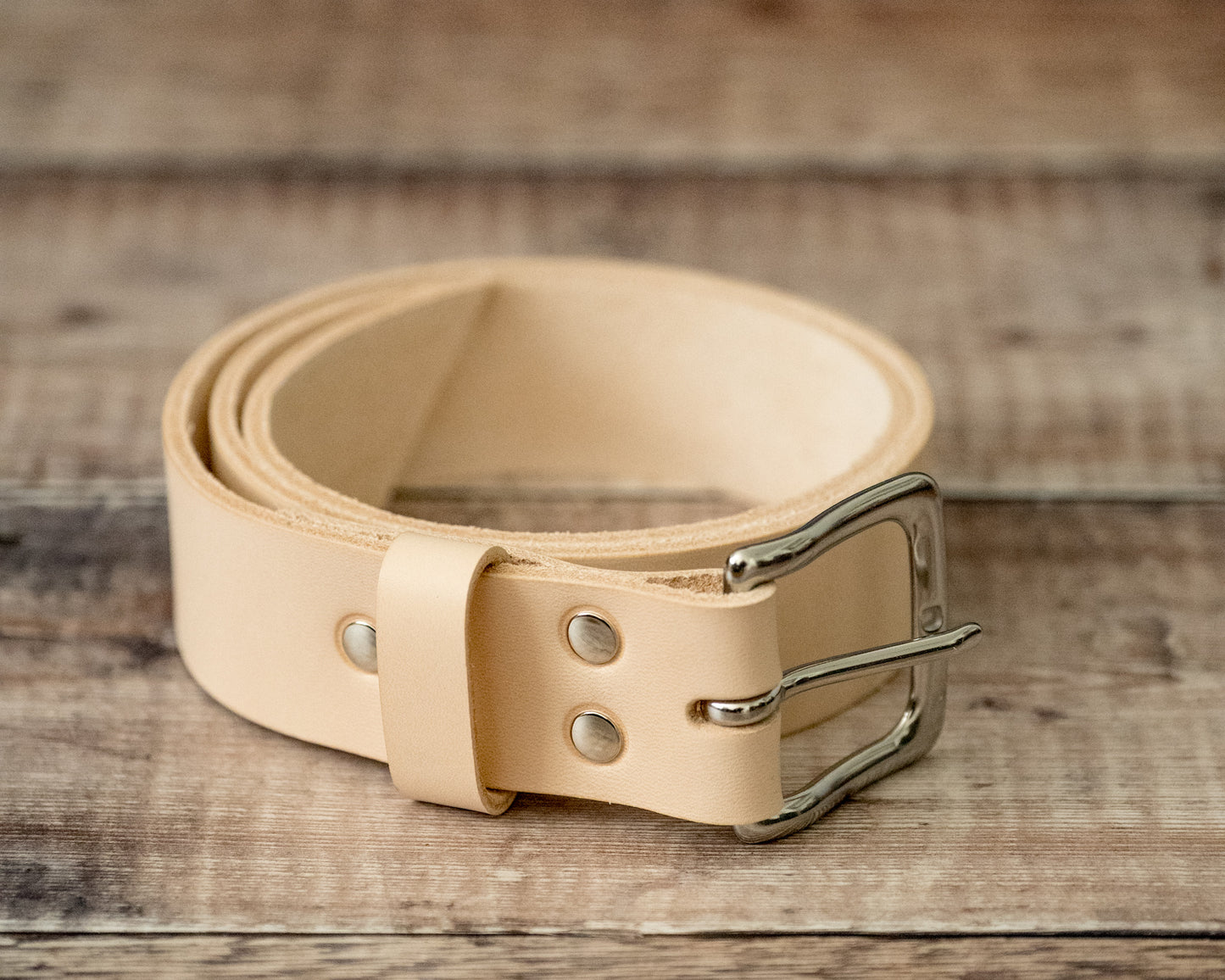 Stainless steel buckle detail on handmade natural leather belt