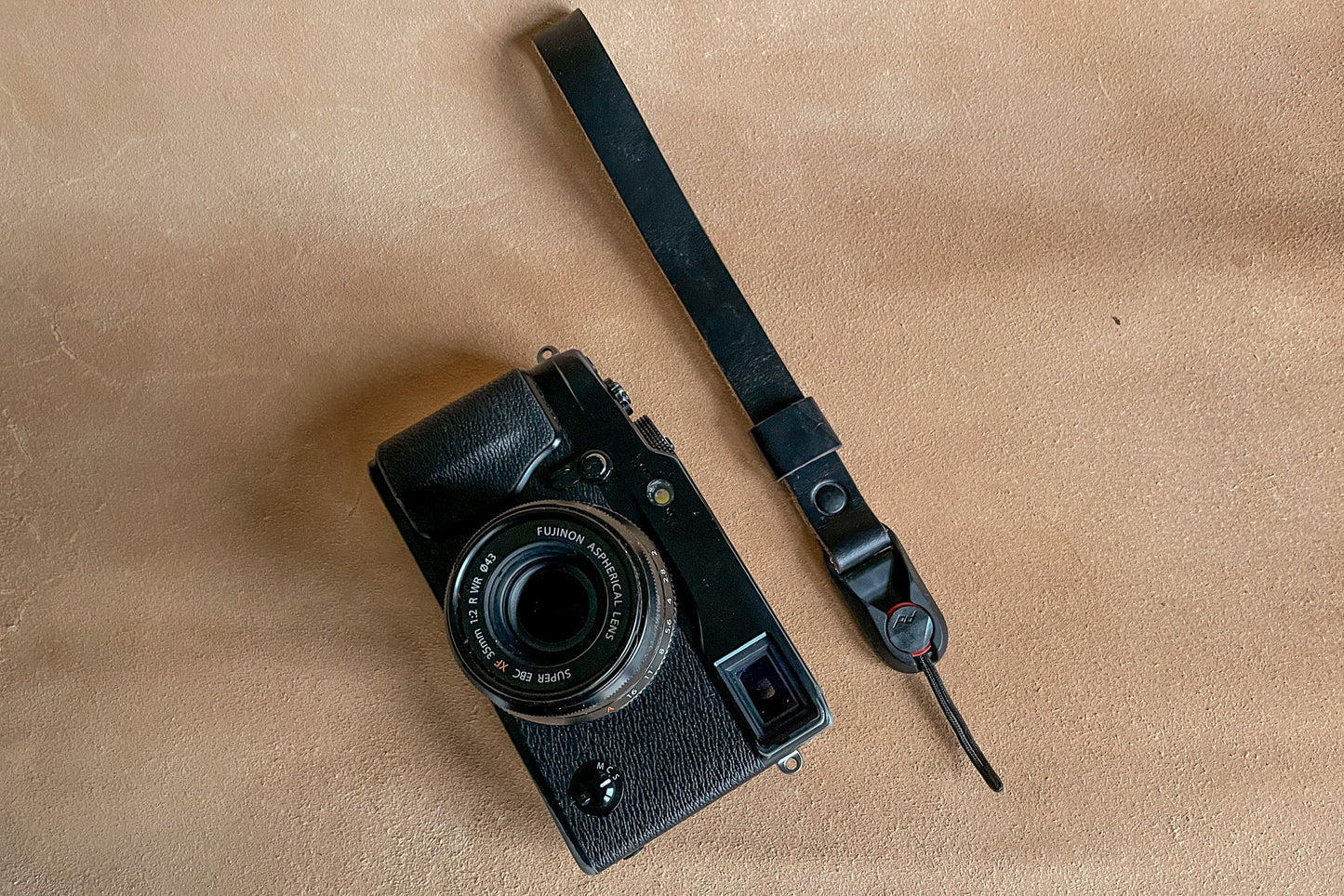 Close-up of Peak Design AL-4 anchor link on Horween leather wrist strap