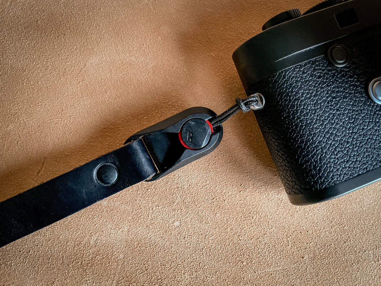 Double-capped black rivets on handmade Horween leather wrist strap