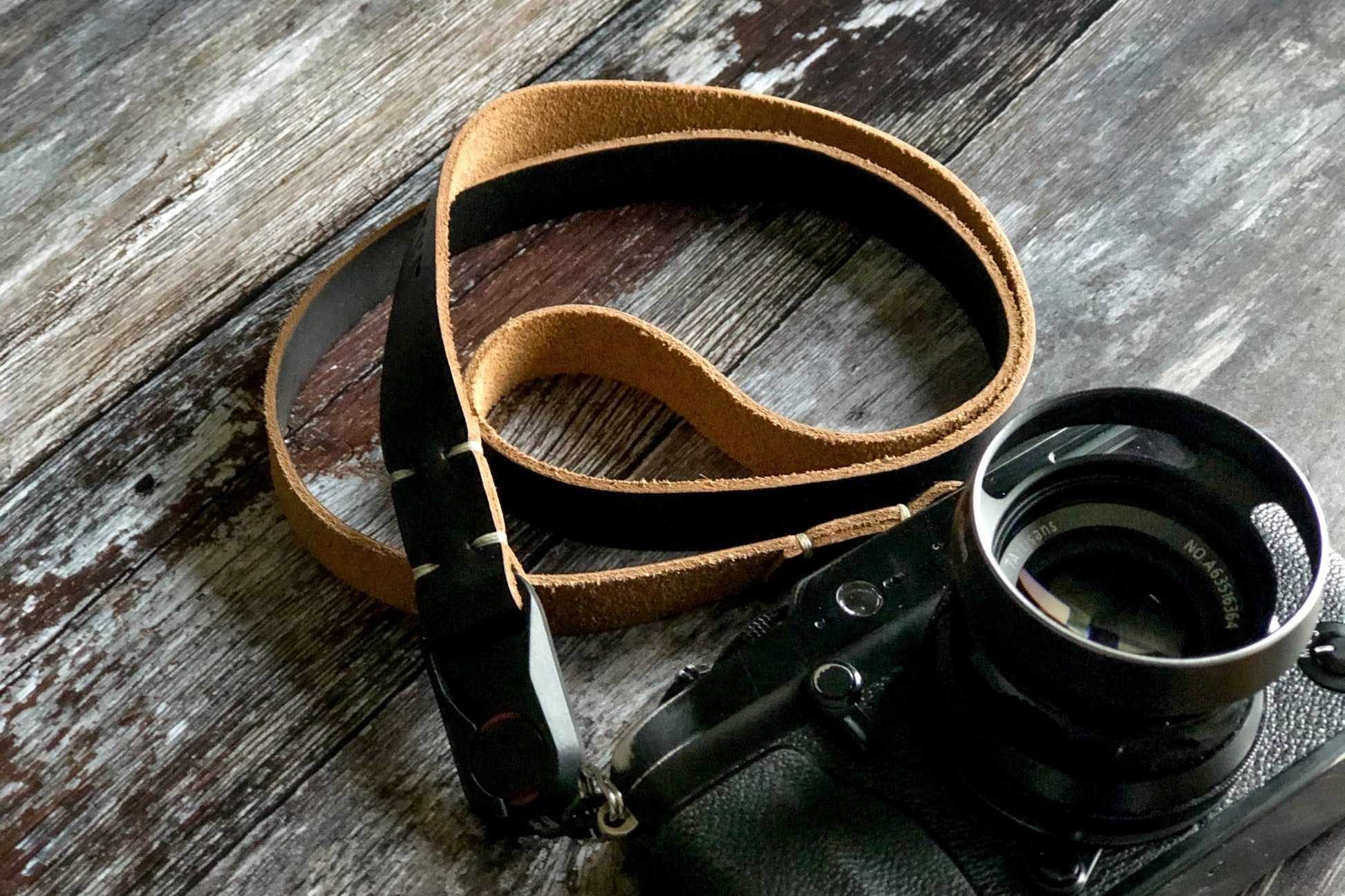 Hand-stitched polyester thread detail on Horween leather camera strap