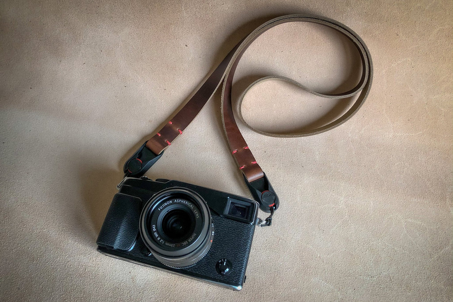 Close-up of Peak Design AL-4 anchor link on Horween leather neck strap