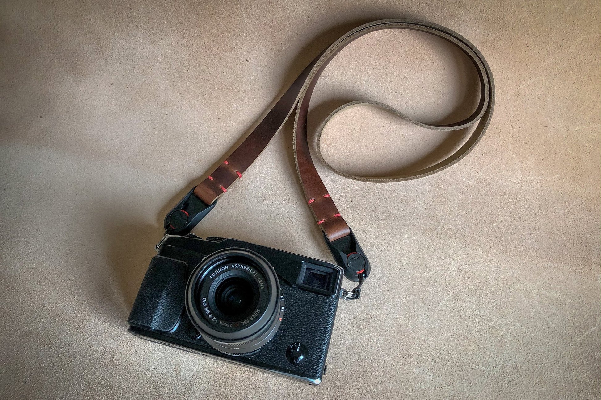 Close-up of Peak Design AL-4 anchor link on Horween leather neck strap