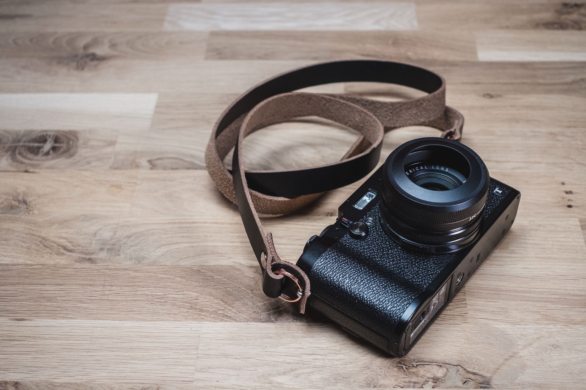 VANTAGE leather camera strap attached to camera showing 16mm width and bumpers
